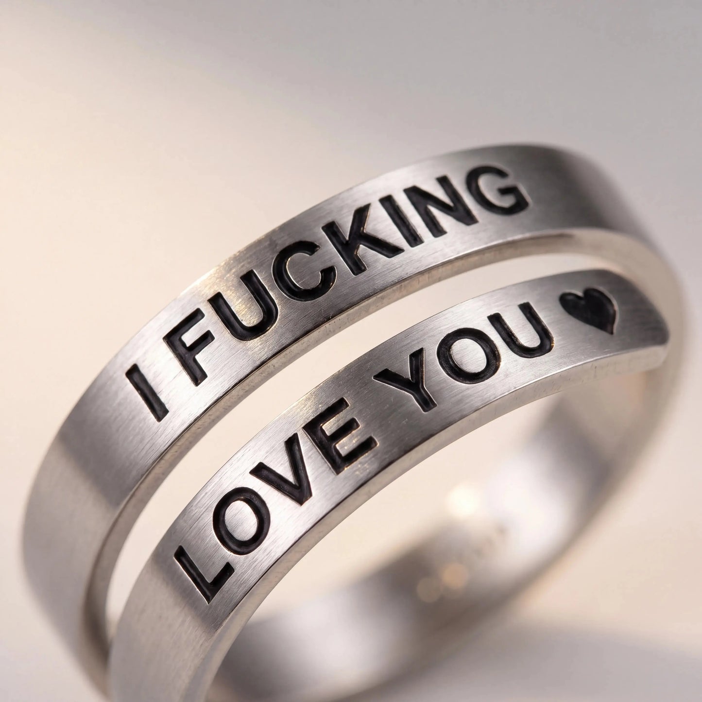 Close-up of I Fucking Love You Engraving on Stainless Steel Spiral Ring